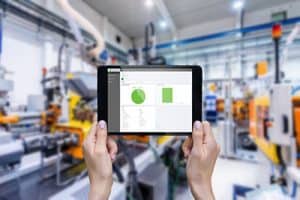 tablet displaying metrics of efficiency in industry 4.0 enabled manufacturing